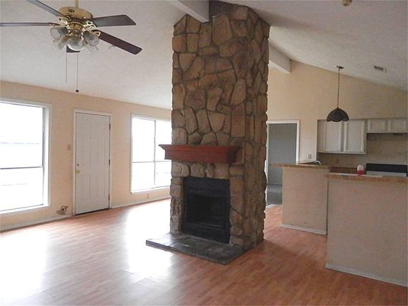 A wall of windows shines into the living room and dining areas.
