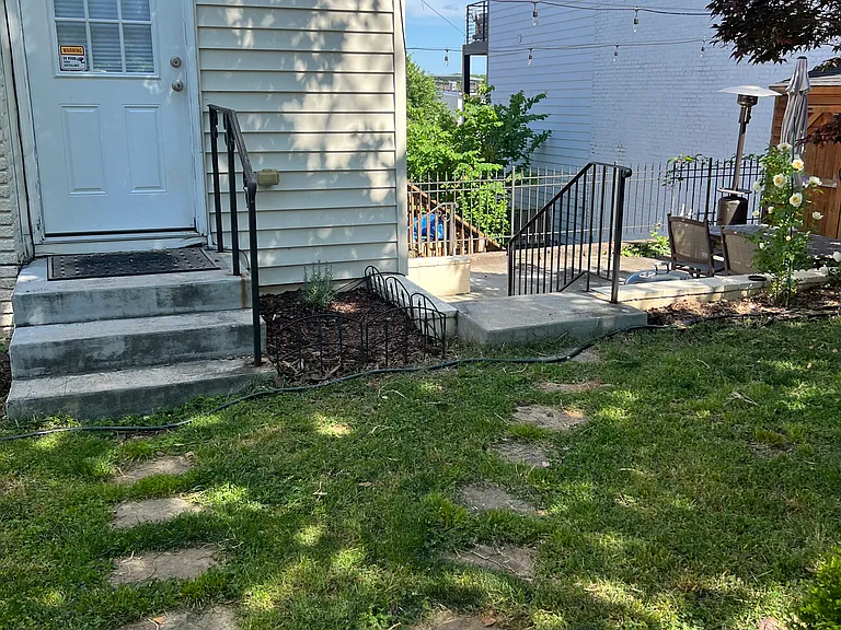 Right-side stone path leads to private entrance off of 3rd St NE.