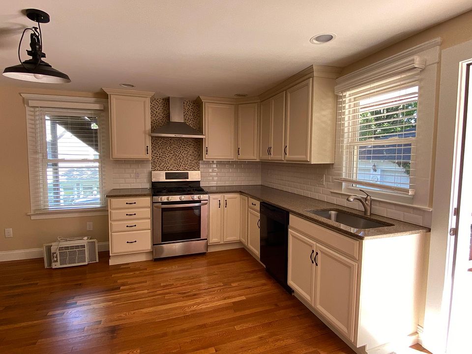 kitchen includes, built in modern ceiling lights, quartz counters, custom cabinets, gas range stove, stainless steel appliances, brand new backsplash and cooking vent fan, and a concealed washer and drier hook-up.