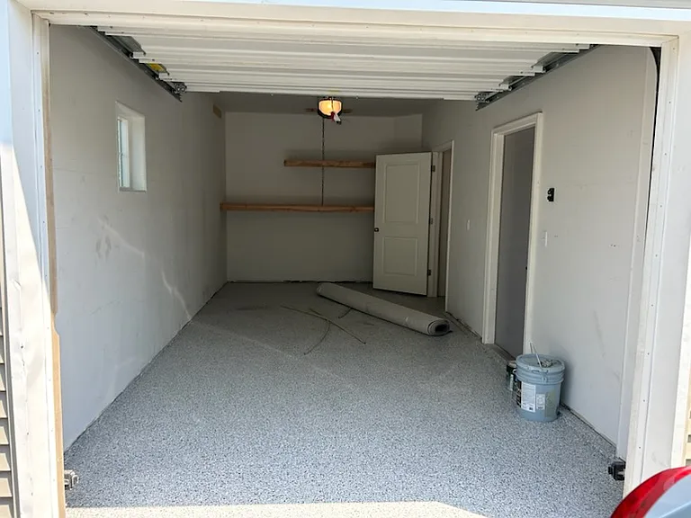 21' X 10' w storage shelves. Please notice epoxy floors.