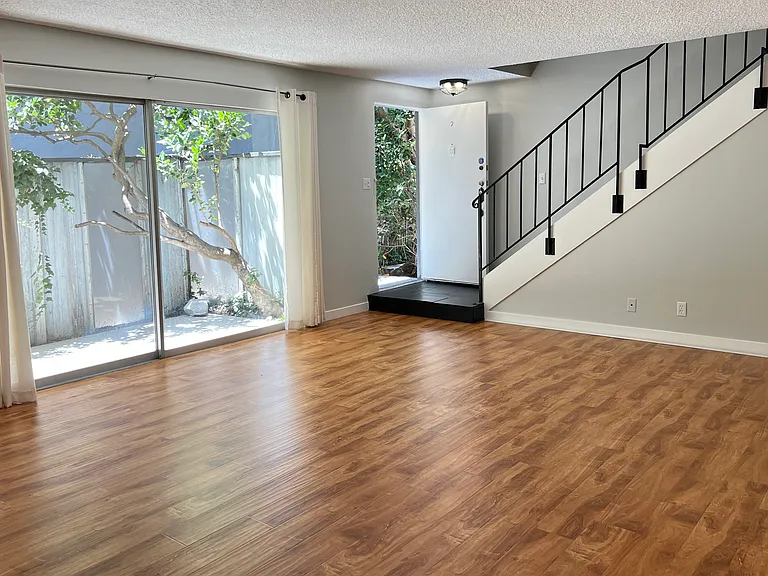 Living room (vacant) opens to patio