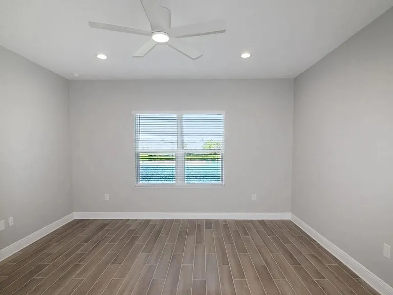 Spacious Primary Bedroom - the picture does not do it justice. Notice the beautiful water view and ceiling fan!
