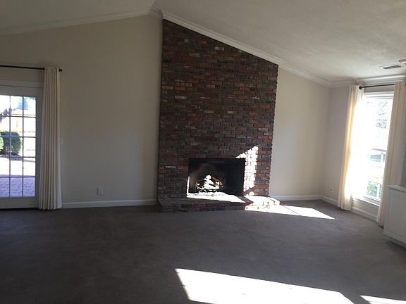 Spacious den with brick fireplace