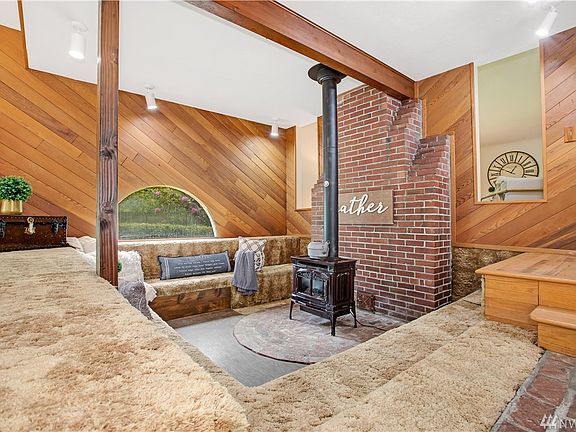 The cozy sunken area with its free-standing gas fireplace invites warm conversations.