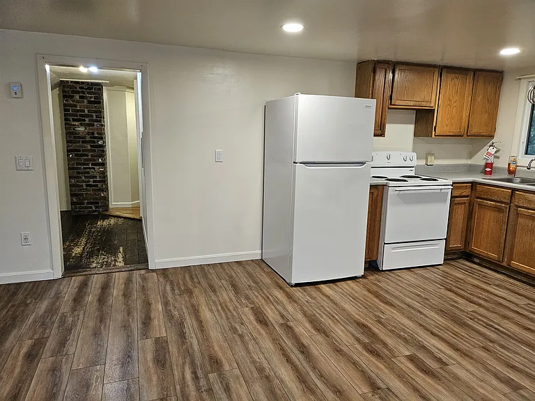 Kitchen exits to an open hallway which is large enough for a small office.