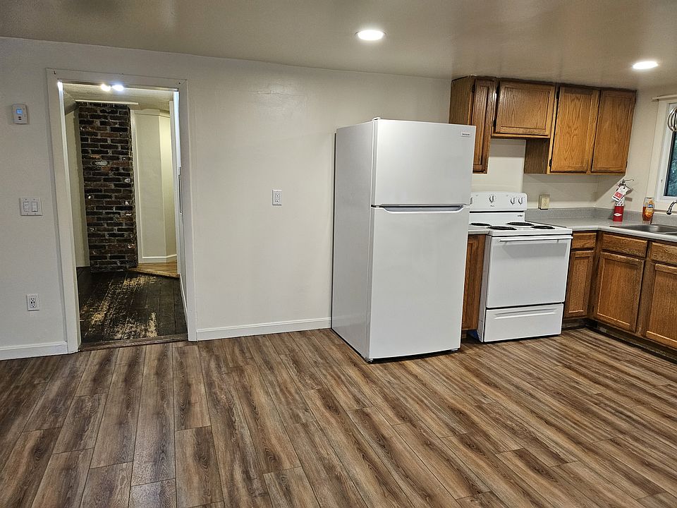 Kitchen exits to an open hallway which is large enough for a small office.