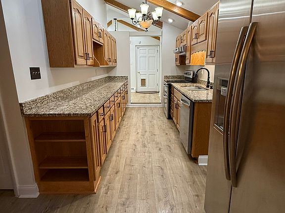 Gally Kitchen with refrigerator, double oven stove and tons of cabinets and counter space