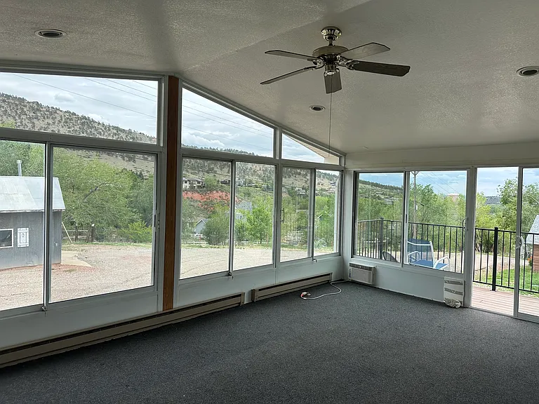 Large sunroom living space with attached deck