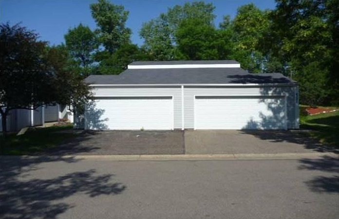 Front of the house (new roof, a two-car garage with driveway)