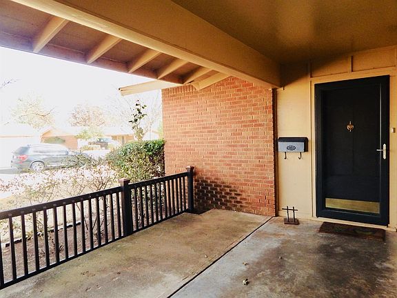 Oversized,  Covered Front Porch With Decorative Railing.