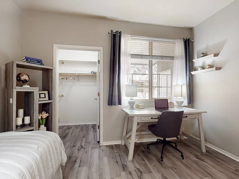 Experience the perfect blend of comfort and productivity in this stylish bedroom with a dedicated workspace.