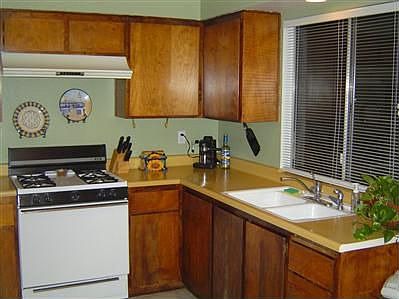 Kitchen with beautiful cabinets and refigerator is included