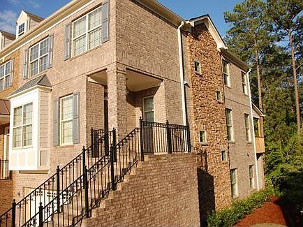 Four sided brick and stone home with covered deck and patio.