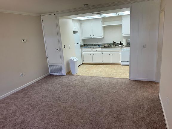 Large living room with new: carpeting, baseboards. Large kitchen with lots of cabinets and amenities.