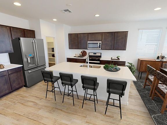 This photo showcases a virtually staged kitchen in a Lantana Plan Home.