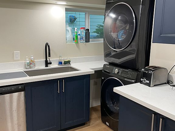Kitchen with in-unit washer/dryer.