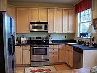 Custom Maple cabinets & stainless appliances make this eat-in kitchen shine!