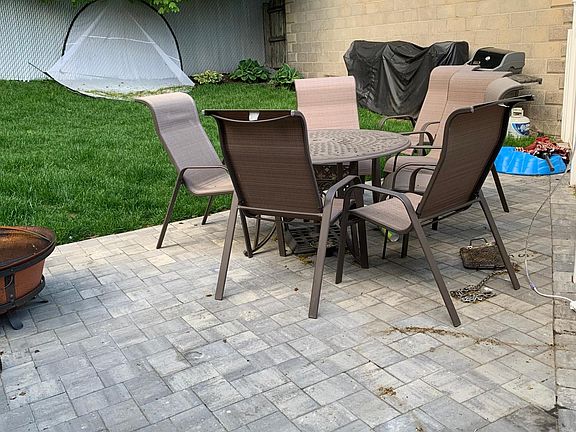 Back patio connected to the unit with grill and fire pit. Yard is shared between both units.