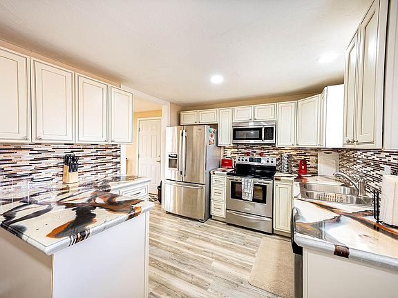 Updated kitchen has all the amenities, including cookware, plate ware, blender, and much more