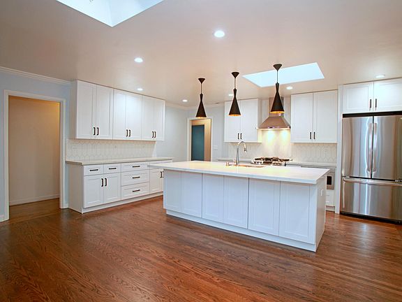 Newly renovated kitchen with large island, hardwood floors and lots of storage