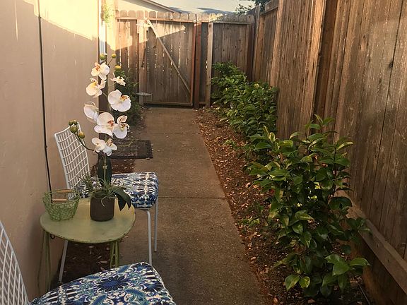 Side garden with fresh air seating.