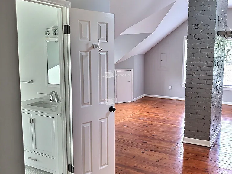 Looking into bathroom and living room TALL CEILING