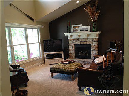 Living Room Features Cathedral Ceilings and Stone Fireplace