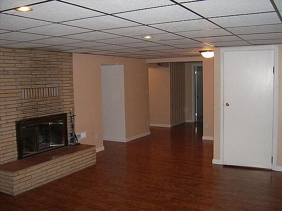 part of downstairs family room with wood fireplace
