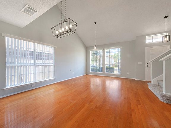 another view of the open area with lots of natural light. new paint and light fixtures.