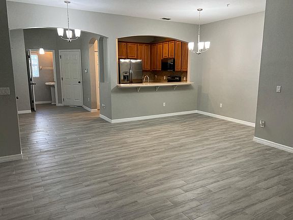 Living Room view to kitchen and half guest bathroom.