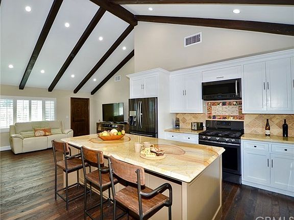 VIEW OF THE KITCHEN LOOKING TOWARD THE FRONT DOOR.