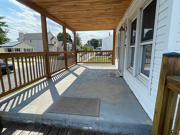Spacious covered front porch. Perfect for relaxing, enjoying morning coffee, or unwinding at the end of the day.