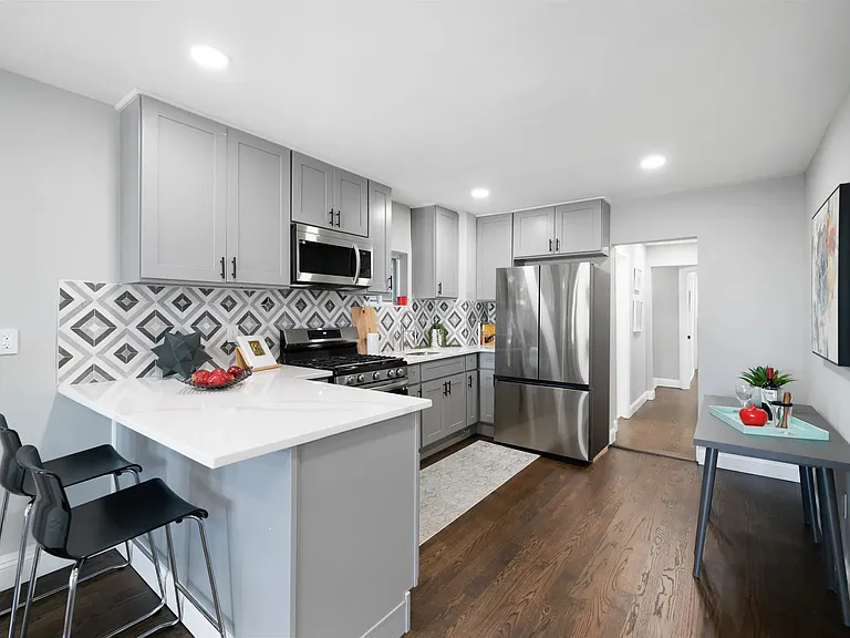 Kitchen with dishwasher and all stainless steel appliances.