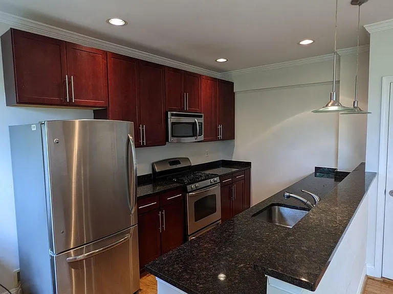 Large and Spacious Kitchen with Granite Countertops and Stainless Steel Appliances