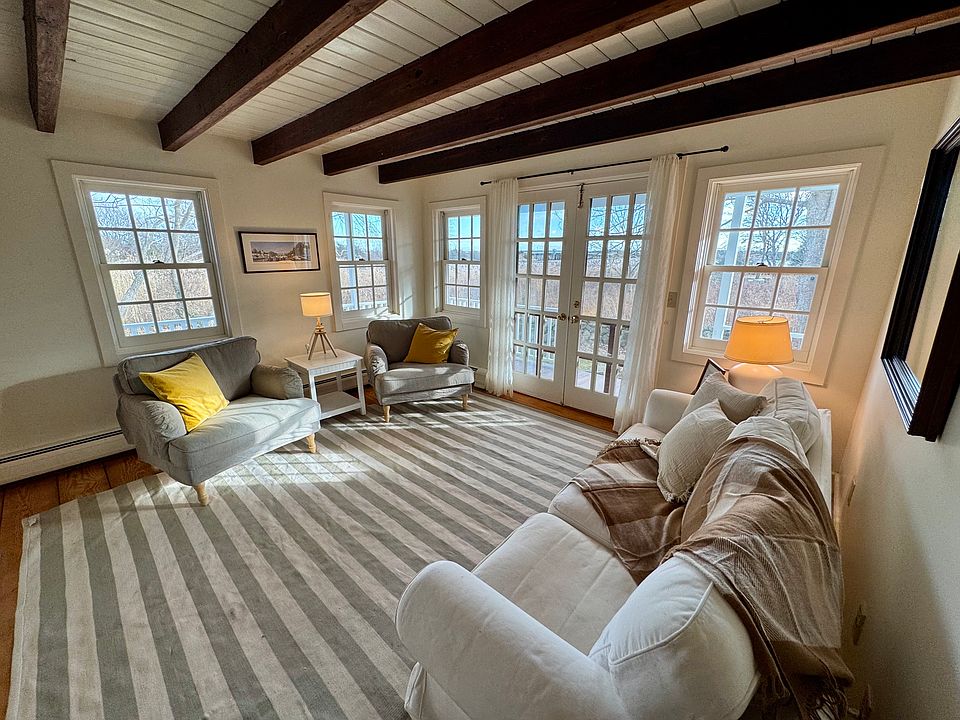 Living room - has beautiful river views of the Westport River. Opens on to a wrap-around porch.