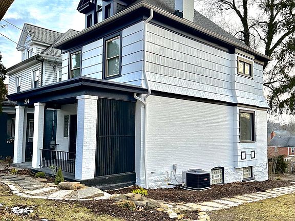 Large front porch with custom privacy wood detail.