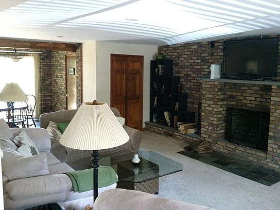 Family room with Exposed Brick & Fireplace