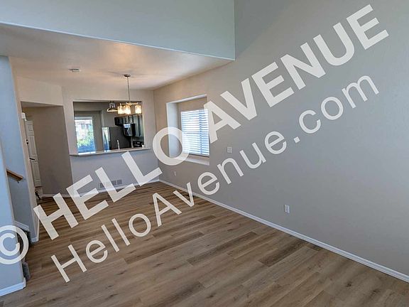 Living room looking into the dining and kitchen