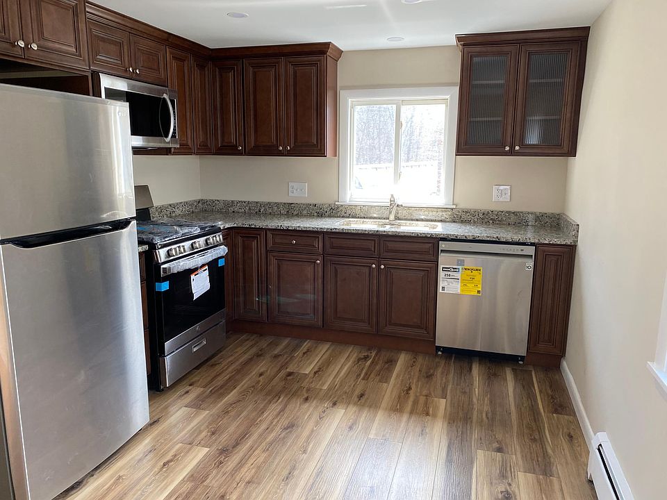 Upgraded kitchen with granite countertops and wood plank flooring.