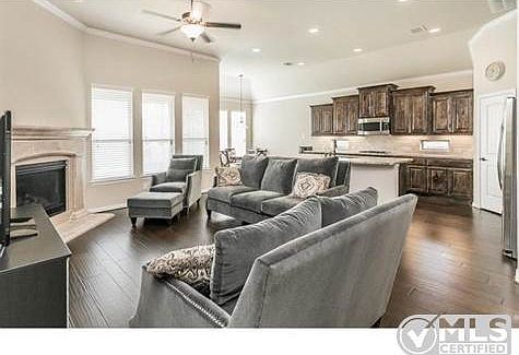 Expansive living room with a ceiling fan!