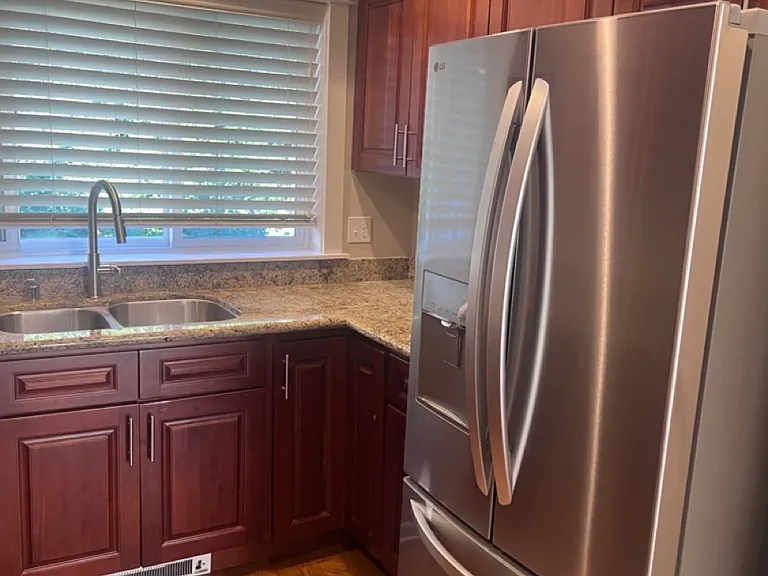 Newer appliances in fully equipped kitchen.