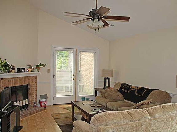 Living room w/vaulted ceiling and fireplace.