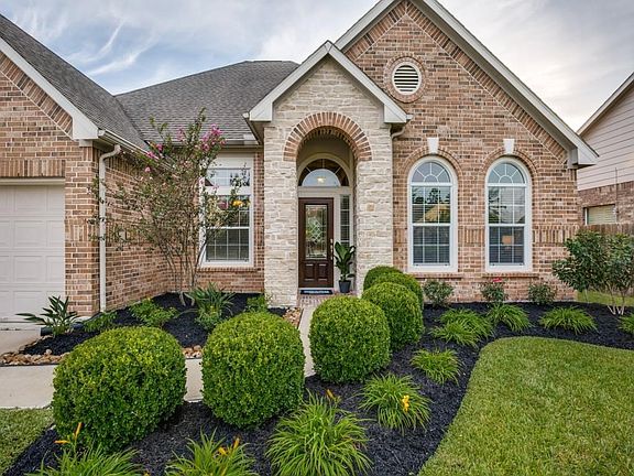 Notice the lush landscaping that leads you and your guest to the beautiful leaded glass front door