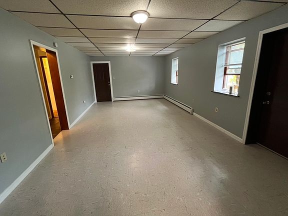 Livingroom area, Balcony door on the right, hallway to bedrooms and bathroom on the left.