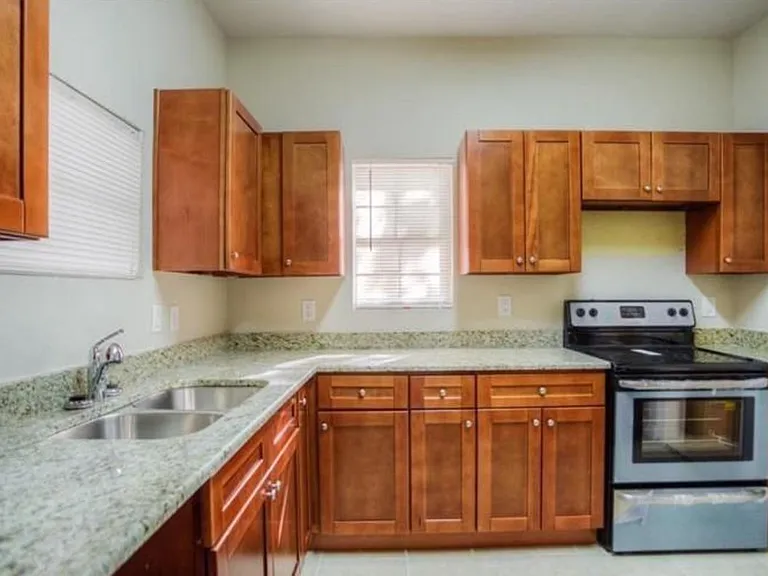 Spacious kitchen with granite countertops.