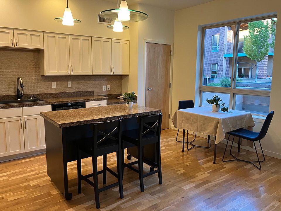 Movable island with storage and room for a dining table and chairs.