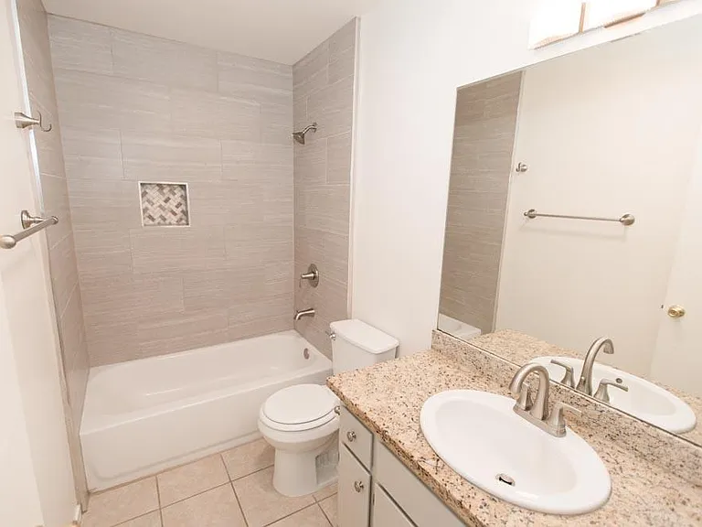 Second bathroom, tiled bath.