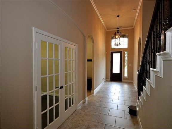 This entry leads to a bedroom/study at the front of the home, full secondary bathroom, and a formal dining with French doors.