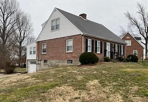Side view of this al brick house with a tuck under garage