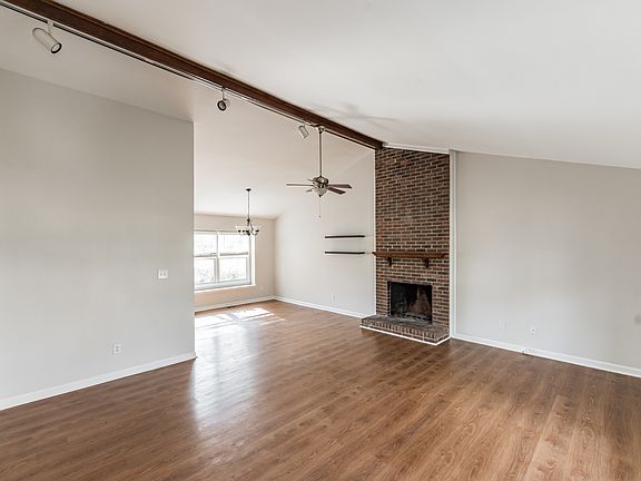 Open floor plan with a spacious living room, vaulted ceilings and fireplace